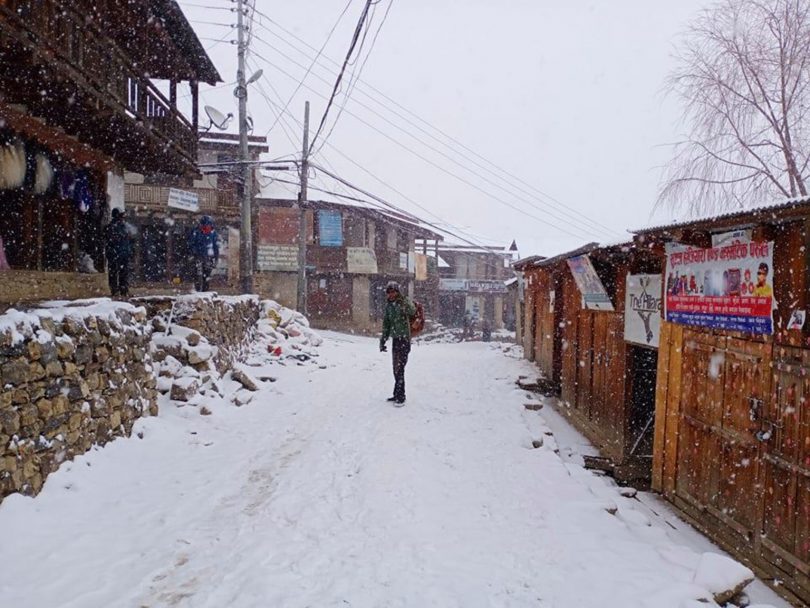 A foreign national cleans up Simkot Bazaar